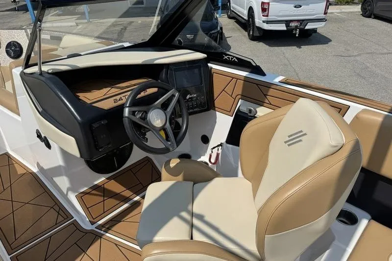 Slide: The Image of 2021 ATX Surf Boats 24 Type-S interior with tan seating and modern dashboard. - 14