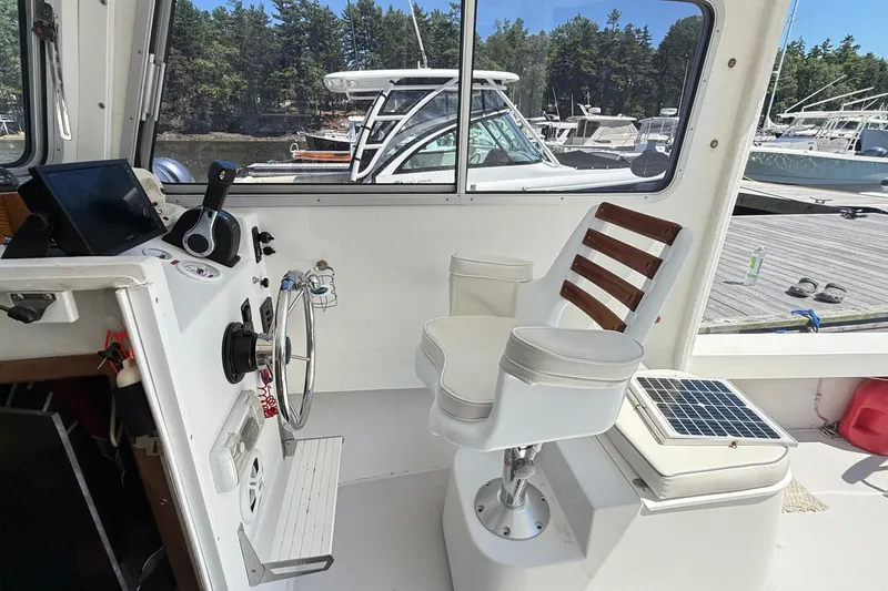 Slide: The Image of Interior of a 2020 Seaway 24 boat with steering wheel and captain's chair. - 16