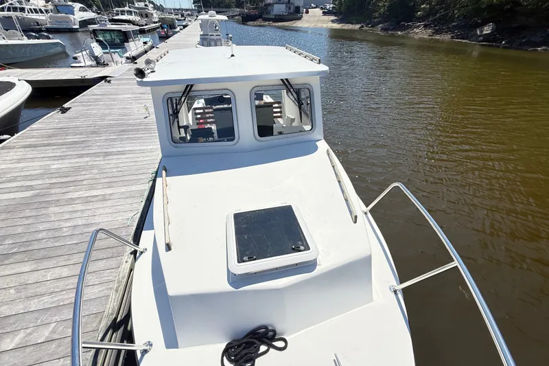 Slide: The Image of 2020 Seaway 24 boat docked at marina, featuring a sleek white deck and cabin. - 28