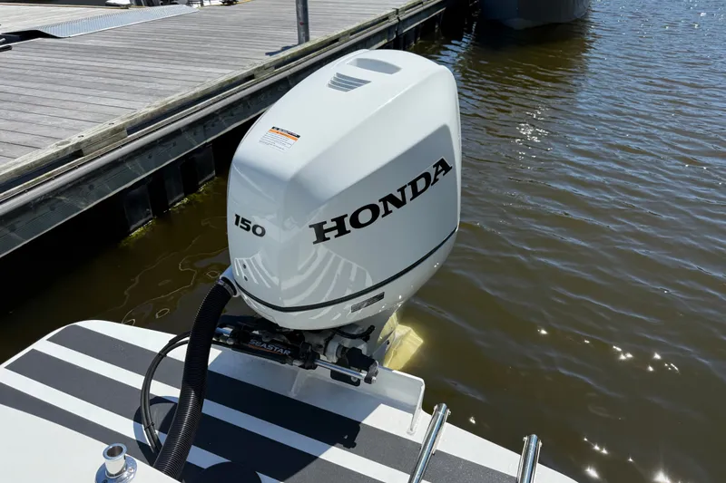 Slide: The Image of Honda 150 outboard motor on 2020 Seaway 24 boat docked by wooden pier. - 37