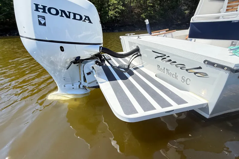 Slide: The Image of Seaway 24 boat with Honda outboard motor, 2020 model, featuring a striped swim platform. - 38