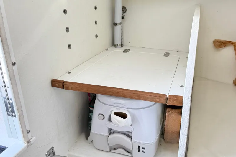 Slide: The Image of Compact marine toilet setup in a 2020 Seaway 24 boat interior. - 24