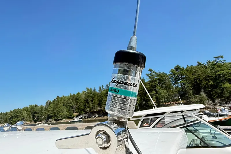 Slide: The Image of Antenna on 2020 Seaway 24 boat with clear blue sky and forested shoreline. - 34