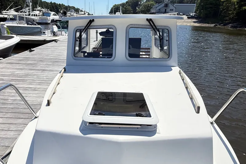 Slide: The Image of 2020 Seaway 24 boat docked at marina, front view with cabin windows. - 32
