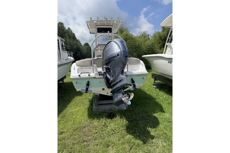 Slide: The Image of 2027 Key West 203 FS boat with outboard motor on grassy area. - 6