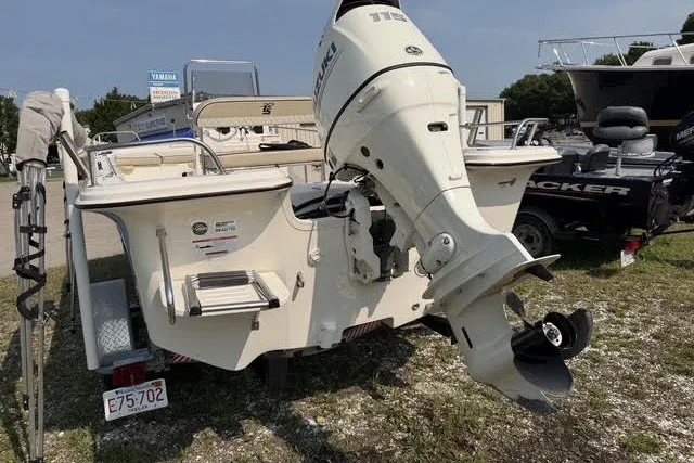 Slide: The Image of 2020 Carolina Skiff 19 LS boat with outboard motor, parked on grass. - 3
