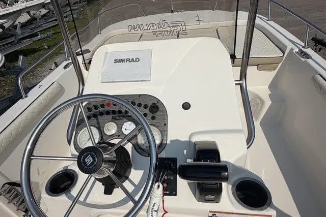 Slide: The Image of 2020 Carolina Skiff 19 LS boat dashboard with steering wheel and Simrad navigation system. - 7