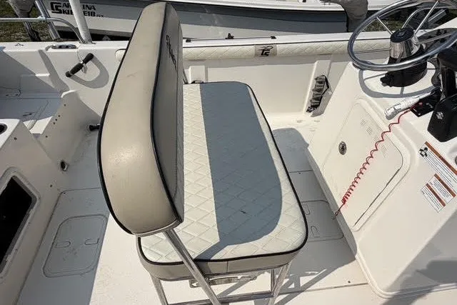 Slide: The Image of 2020 Carolina Skiff 19 LS boat interior with cushioned seating and steering console. - 5