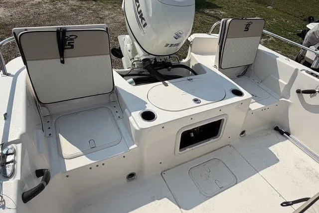 Slide: The Image of 2020 Carolina Skiff 19 LS boat interior with Suzuki outboard motor and storage compartments. - 4