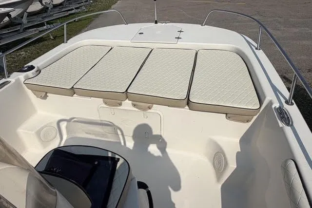 Slide: The Image of 2020 Carolina Skiff 19 LS boat interior with cushioned seating and storage compartments. - 10