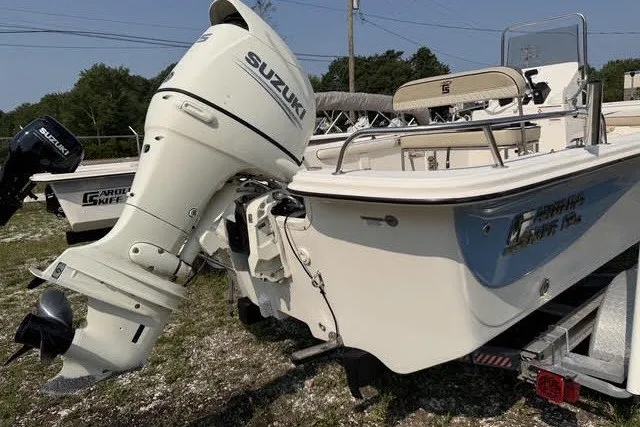 Slide: The Image of 2020 Carolina Skiff 19 LS boat with Suzuki outboard motor on trailer. - 2