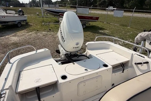 Slide: The Image of 2020 Carolina Skiff 19 LS boat with Suzuki 115 outboard motor, parked on grass. - 14