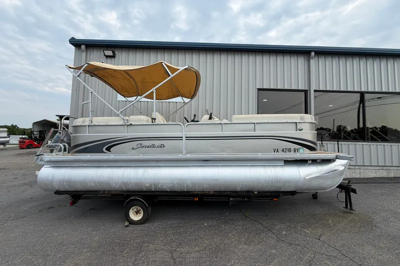 Slide: The Image of 2014 Godfrey SWEETWATER 2086 pontoon boat with canopy, parked outside a building. - 2
