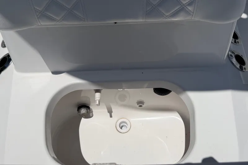 Slide: The Image of Close-up of a white boat cooler with padded seating. - 24