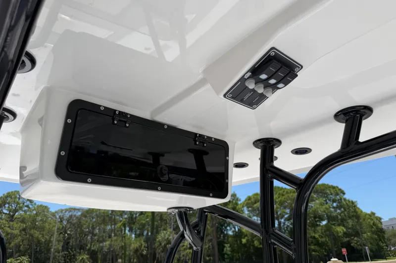 Slide: The Image of 2026 BlackJack 224 boat console with storage compartment and control panel, featuring sleek black supports. - 16