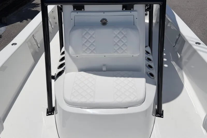 Slide: The Image of The image shows the seating area of a BlackJack 224 boat with white upholstery and black supports. - 23
