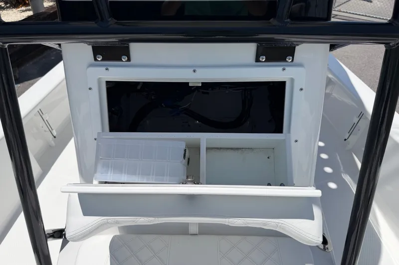 Slide: The Image of 2026 BlackJack 224 boat storage compartment with open hatch and organized interior. - 25