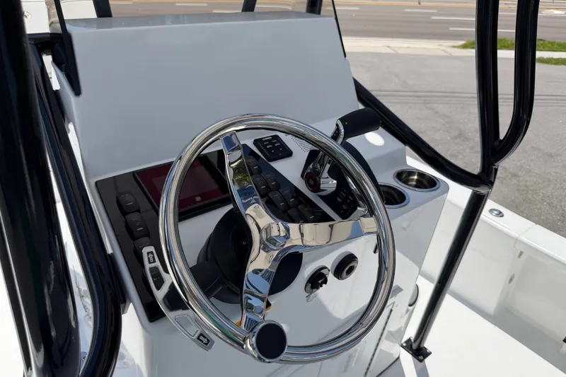 Slide: The Image of Steering console of 2026 BlackJack 224 boat with chrome wheel and controls. - 26