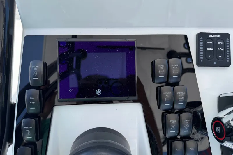 Slide: The Image of Control panel of BlackJack 224 boat, featuring various switches and a digital display, 2026 model. - 17