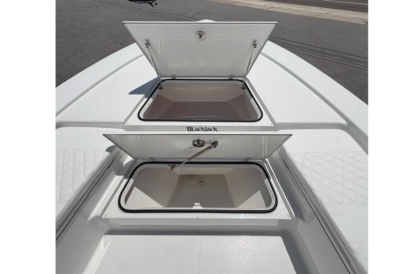 Slide: The Image of 2026 BlackJack 224: Two open storage compartments on the deck of a white boat. - 21