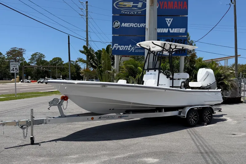 The Image of A 2026 BlackJack 224 boat on a trailer, parked in a lot under sunny weather. - 0