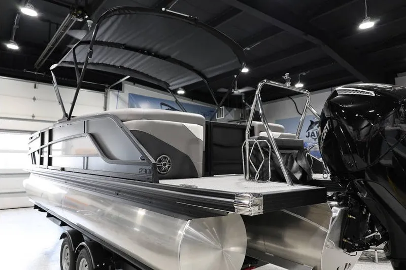 Slide: The Image of 2026 Evotti 523QL OMNI pontoon boat in showroom, featuring sleek design and powerful engine. - 7