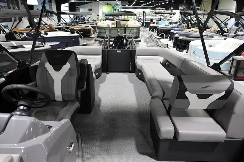 Slide: The Image of Interior of 2026 Evotti 523QL OMNI boat at a showroom, featuring modern seating and steering. - 13