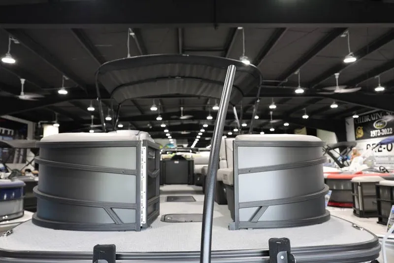Slide: The Image of 2026 Evotti 523QL OMNI pontoon boat displayed in a showroom with modern lighting. - 3