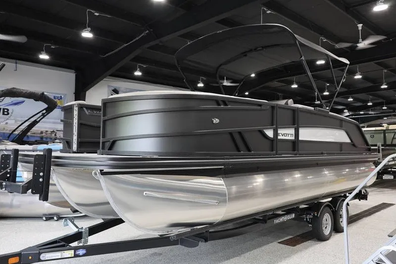 Slide: The Image of 2026 Evotti 523QL OMNI pontoon boat displayed indoors on a trailer. - 2