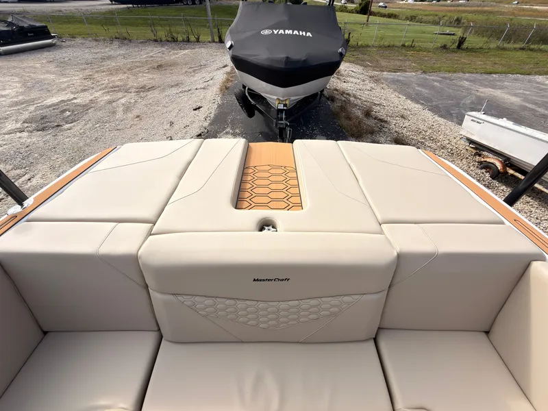 Slide: The Image of The image shows the stern of a MasterCraft NXT22 boat with beige upholstery and a Yamaha boat in the background. - 9