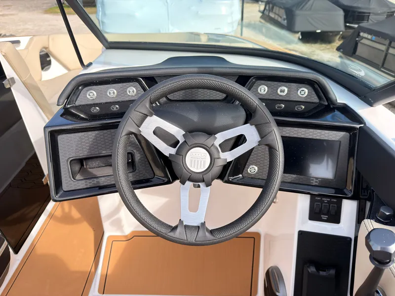 Slide: The Image of The image shows the cockpit of a 2027 MasterCraft NXT22 with a modern steering wheel and dashboard. - 44