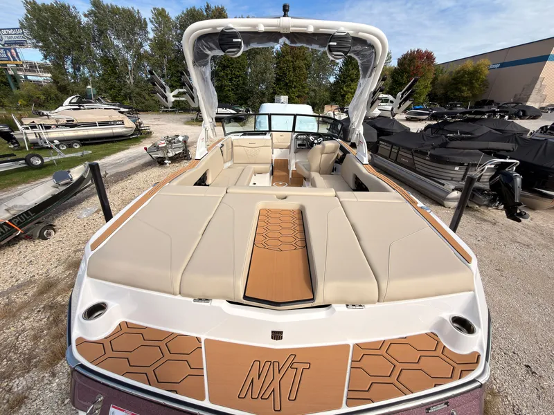 Slide: The Image of The image shows a 2027 MasterCraft NXT22 boat with beige seating and a modern design. - 8