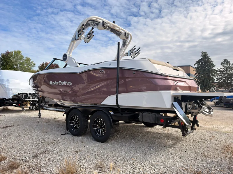 Slide: The Image of 2027 MasterCraft NXT22 on a trailer, featuring a tower and sleek design. - 6