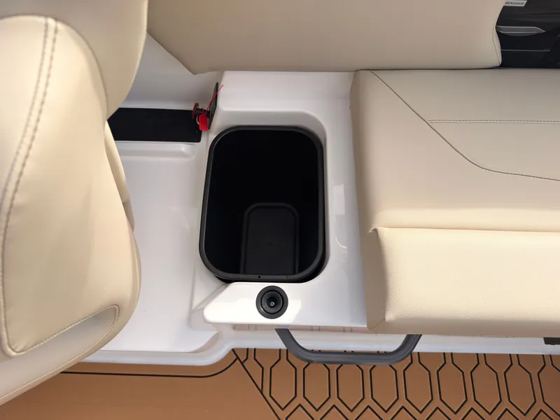 Slide: The Image of An open storage compartment on a boat with beige upholstery and a textured floor. - 20