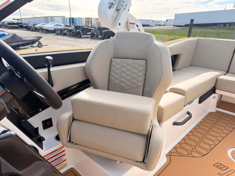 Slide: The Image of The image shows the interior of a 2027 MasterCraft NXT22 with beige leather seating. - 43