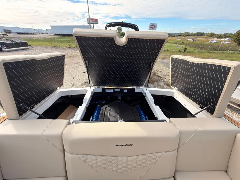 Slide: The Image of The image shows the engine compartment of a MasterCraft NXT22 boat with open hatches. - 16