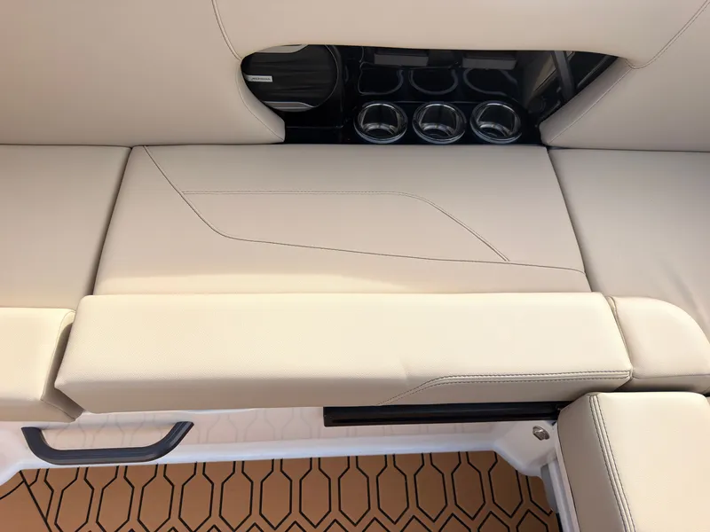 Slide: The Image of The image shows the beige upholstery of a 2027 MasterCraft NXT22 with cup holders. - 21