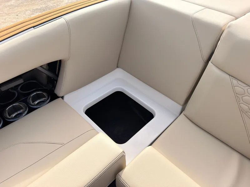 Slide: The Image of The 2027 MasterCraft NXT22 features sleek beige upholstery with integrated storage space. - 24