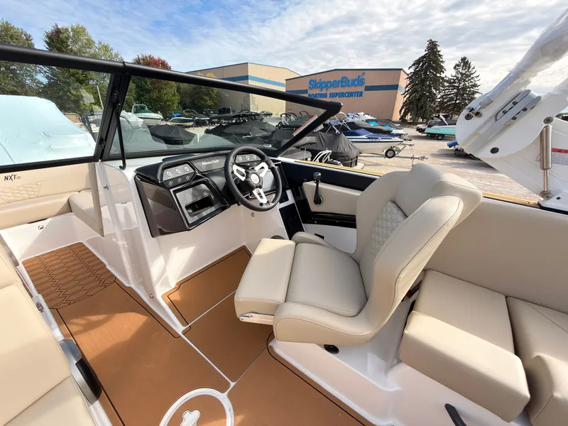 Slide: The Image of The image shows the cockpit of a 2027 MasterCraft NXT22 boat with beige seating. - 41