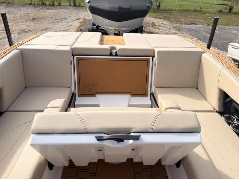 Slide: The Image of The image shows the cockpit of a 2027 MasterCraft NXT22 with beige upholstery. - 26