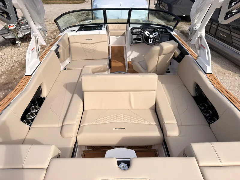 Slide: The Image of The image shows the interior of a 2027 MasterCraft NXT22 with beige leather seating. - 27
