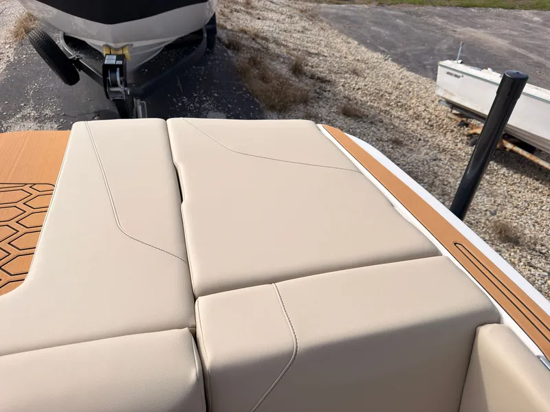 Slide: The Image of The image shows the beige upholstery of a 2027 MasterCraft NXT22 boat. - 12