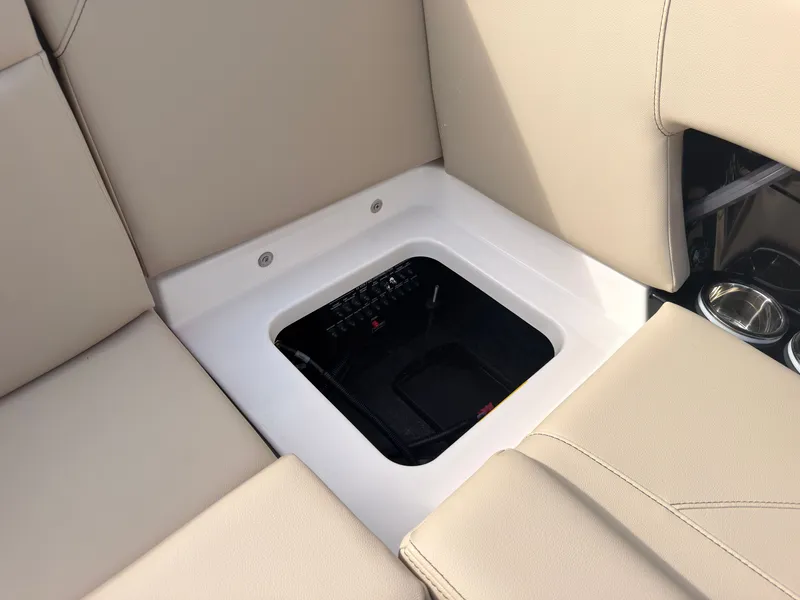 Slide: The Image of The image shows a seating area with beige upholstery and an open storage compartment. - 29