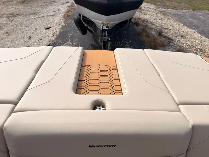Slide: The Image of The image shows the stern of a MasterCraft NXT22 boat with beige upholstery and wood detailing. - 14