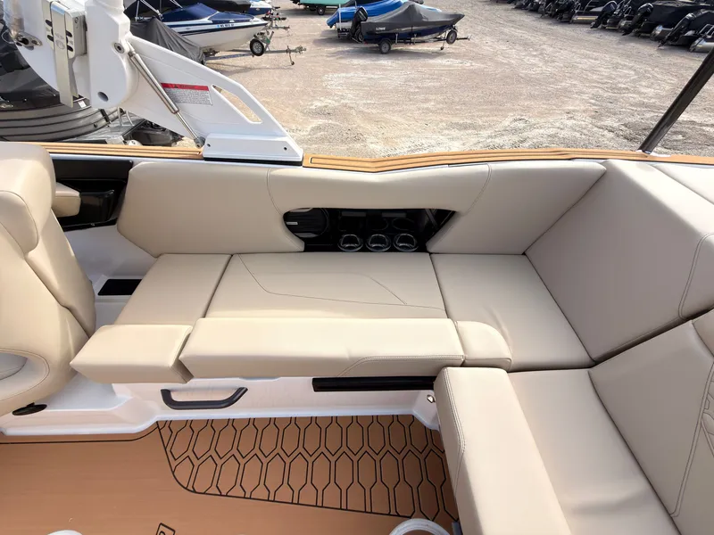 Slide: The Image of The image shows the interior of a 2027 MasterCraft NXT22 boat with beige leather seating. - 18
