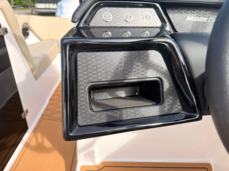 Slide: The Image of Close-up of a MasterCraft NXT22 boat dashboard with modern controls. - 45