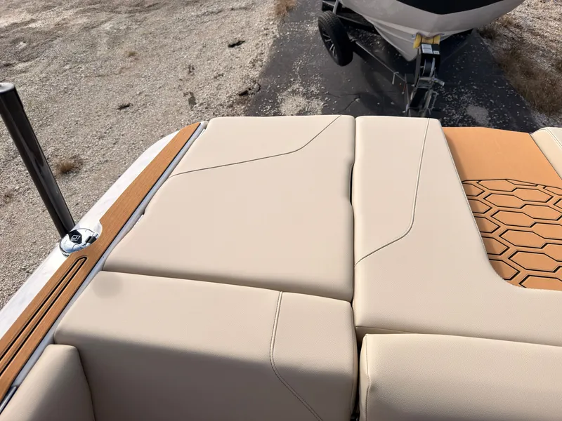 Slide: The Image of The image shows the beige upholstery of a 2027 MasterCraft NXT22, featuring a stylish pattern. - 10