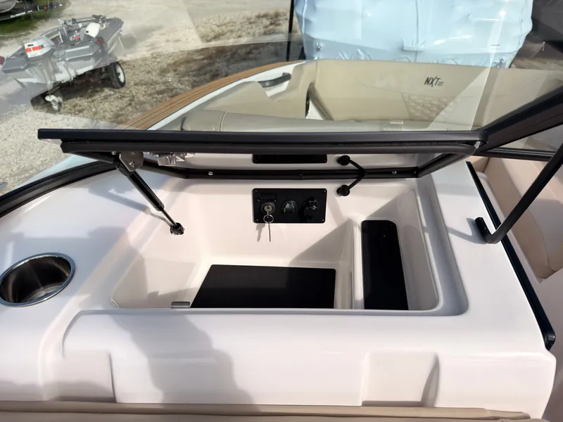 Slide: The Image of The image shows the dashboard of a MasterCraft NXT22 boat with an open storage compartment. - 40