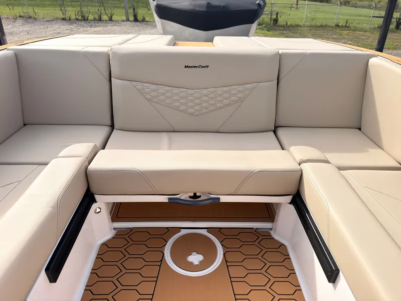 Slide: The Image of The image shows the beige interior of a MasterCraft NXT22 boat with stylish upholstery. - 25