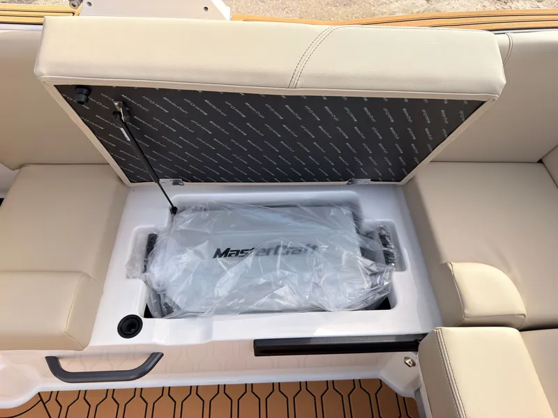 Slide: The Image of The 2027 MasterCraft NXT22 features a seating area with storage underneath. - 22